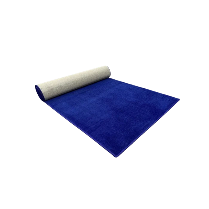 A royal blue carpet runner partly unrolled on a dark surface